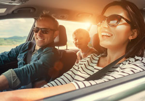 A family driving in a car on a sunny day